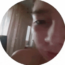 a close up of a man 's face in a circle .