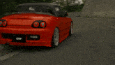 a red ctp sports car is driving down a curvy road