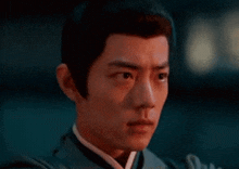 a close up of a man 's face with a serious look on his face