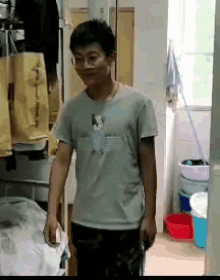a man wearing a gray shirt with a dog on it