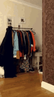 a bunch of clothes hanging on a rack in a closet