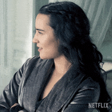 a woman in a grey robe with netflix on the bottom right
