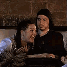 a man and a woman are laughing together and the man says merde !