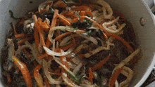 Mixing The Noodles And Vegetables Two Plaid Aprons GIF