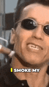 a man wearing sunglasses says " i smoke my "