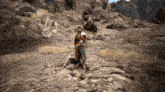 a video game character is standing on a rocky path holding a sword