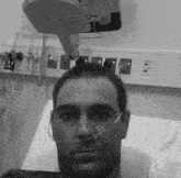 a man is laying in a hospital bed with a sign that says ria