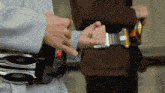a person is wearing a belt with a red button that says ' e ' on it