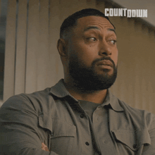 a man with a beard is wearing a shirt that says countdown on it