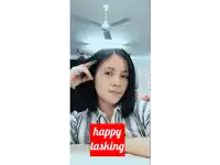 a woman with a ceiling fan behind her and a happy tasking sign