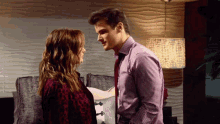 a man and a woman are looking into each others eyes