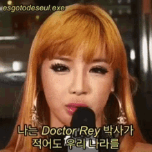 a close up of a woman speaking into a microphone with the words doctor rey written on the bottom