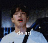 a close up of a man 's face with the word de ari written on it