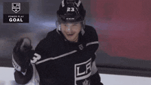 a hockey player with the number 23 on his helmet celebrates a la power play goal