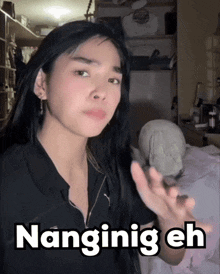 a woman with long black hair says " nanginig eh " in white letters