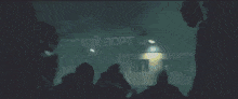 a group of people are standing in front of a large fire .