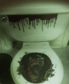a toilet with a picture of a bloody face on the seat