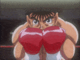 a cartoon character wearing red boxing gloves looks angry