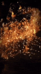 a close up of a fire with a lot of flames coming out of it