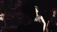 a man with green hair is wearing a tank top that says ' guns n ' roses '
