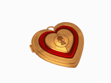 a gold heart shaped locket with a picture of a man inside