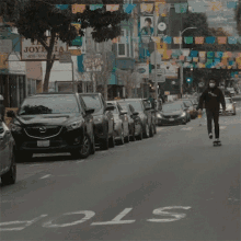 a man wearing a mask is riding a skateboard down a street in front of a joyeria sign