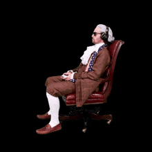 a man wearing a wig and headphones is sitting in an office chair playing a video game
