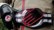a person is wearing a belt with a red stripe and the letter e on it