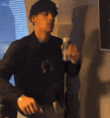 a blurry picture of a man holding a can of beer