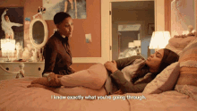 a woman laying on a bed with the words " i know exactly what you 're going through " below her