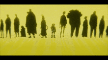 a group of people standing next to each other on a yellow screen