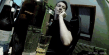 a man sitting in front of a bottle that says vicelov
