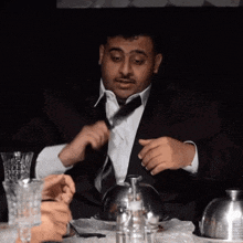 a man in a suit is sitting at a table