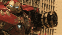 a close up of a red robot with a cannon on its arm