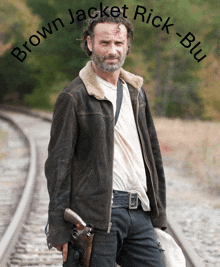 a picture of rick from the walking dead holding a gun