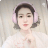 a woman wearing headphones and a shirt that says mickey mouse on it