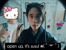 a woman with cat ears is standing next to a man holding a flashlight and a hello kitty head .