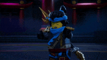 a lego figure with a blue scarf around her head and a trident on her head