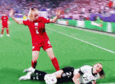 a soccer player in a red jersey with the number 4 on the back