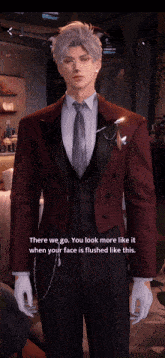 a man in a suit and tie says there we go you look more like it when your face is flushed like this ..
