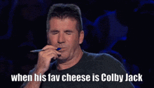 a man with a pen in his mouth and the words when his fav cheese is colby jack