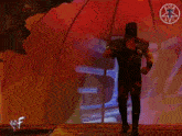 a man in a black and red costume is standing in front of a metal object