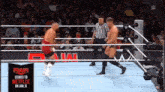 two wrestlers in a wrestling ring with a sign that says raw on it