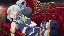 a girl with blue hair is laying on a red couch with the name studio paper cranes written on the bottom