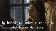 a woman is standing next to a man with the words la bouffe est interdite en dehors des heures de repas written below her