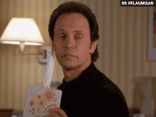 a man is holding a box of tissues in front of his face