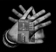 a black and white photo of a hand holding a vision pro card