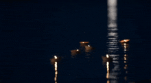 a group of candles are floating in the water