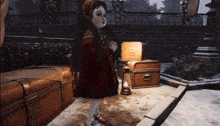 a little girl in a red dress is standing in front of a trunk