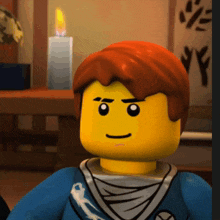 a close up of a lego character with a candle behind him